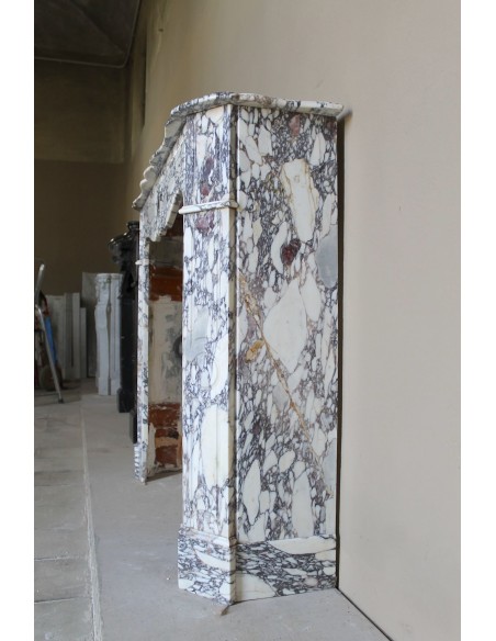 Small antique Baroque fireplace carved in very rare and famous Breccia Violetta marble, an elegant and colorful marble.