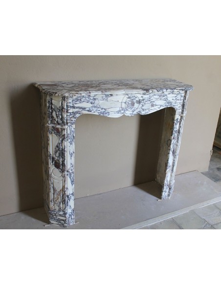 Small antique Baroque fireplace carved in very rare and famous Breccia Violetta marble, an elegant and colorful marble.