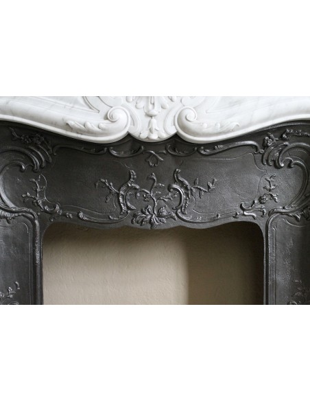 Floral Louis XV fireplace mantel carved in white marble, with shell decorations, complete with its original cast iron insert.