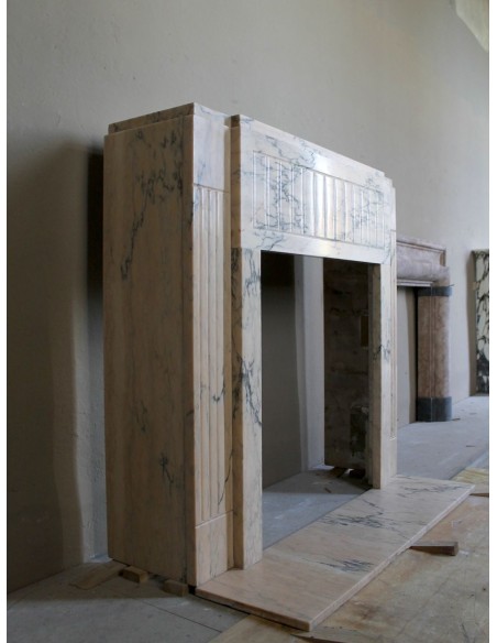 Art Deco mantel carved in veined pink marble called Rosa Portogallo. This antique fireplace comes with its original base.