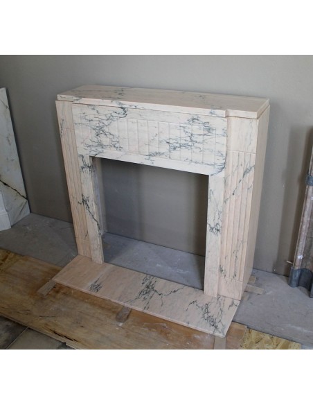 Art Deco mantel carved in veined pink marble called Rosa Portogallo. This antique fireplace comes with its original base.