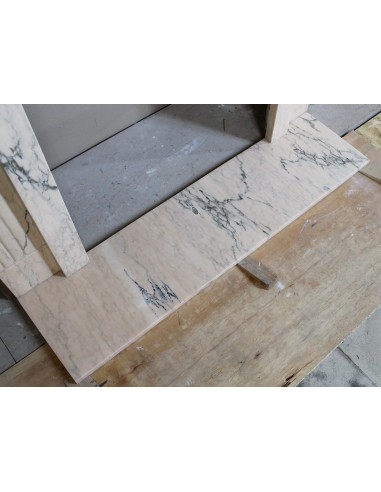 Art Deco mantel carved in veined pink marble called Rosa Portogallo. This antique fireplace comes with its original base.