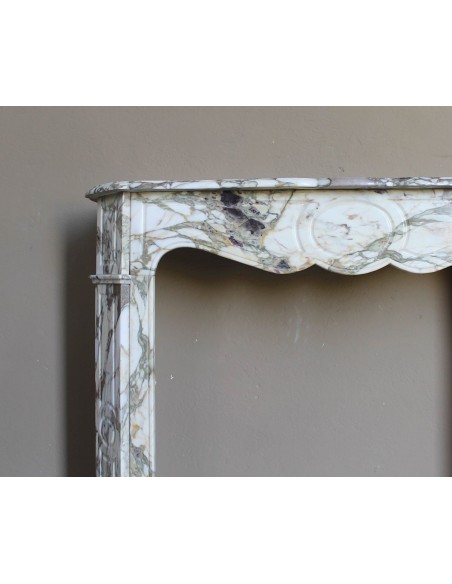 Baroque Pompadour fireplace mantel carved in magnificent Calacatta Gold marble: shades of gold, purple, emerald green, white.