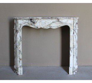 Baroque Pompadour fireplace mantel carved in magnificent Calacatta Gold marble: shades of gold, purple, emerald green, white.