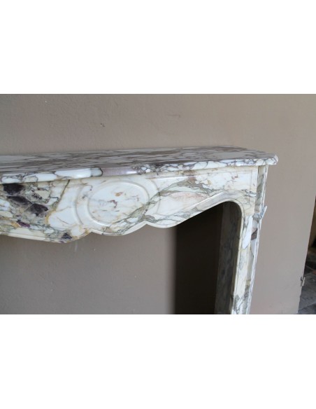 Baroque Pompadour fireplace mantel carved in magnificent Calacatta Gold marble: shades of gold, purple, emerald green, white.