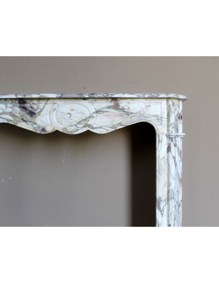 Baroque Pompadour fireplace mantel carved in magnificent Calacatta Gold marble: shades of gold, purple, emerald green, white.