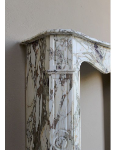 Baroque Pompadour fireplace mantel carved in magnificent Calacatta Gold marble: shades of gold, purple, emerald green, white.