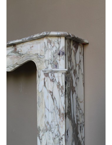 Baroque Pompadour fireplace mantel carved in magnificent Calacatta Gold marble: shades of gold, purple, emerald green, white.