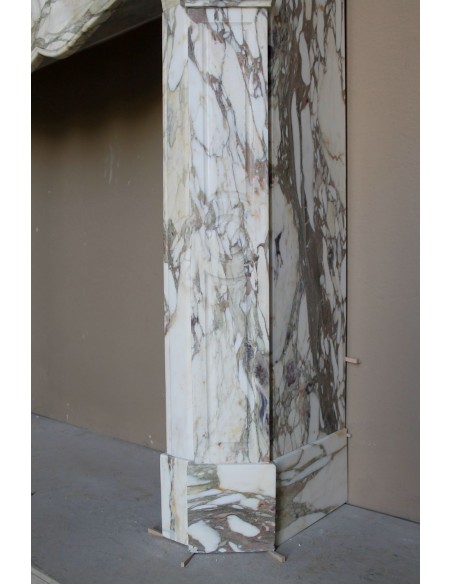 Baroque Pompadour fireplace mantel carved in magnificent Calacatta Gold marble: shades of gold, purple, emerald green, white.