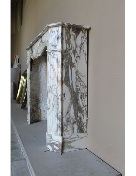 Baroque Pompadour fireplace mantel carved in magnificent Calacatta Gold marble: shades of gold, purple, emerald green, white.