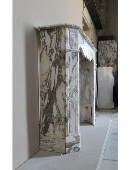 Baroque Pompadour fireplace mantel carved in magnificent Calacatta Gold marble: shades of gold, purple, emerald green, white.