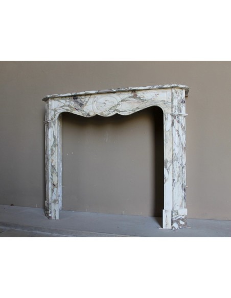 Baroque Pompadour fireplace mantel carved in magnificent Calacatta Gold marble: shades of gold, purple, emerald green, white.