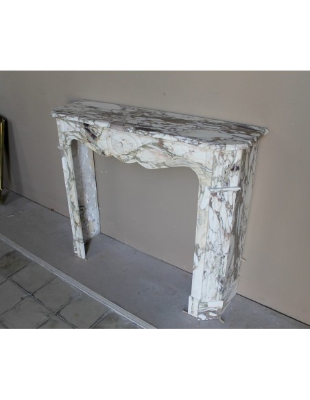 Baroque Pompadour fireplace mantel carved in magnificent Calacatta Gold marble: shades of gold, purple, emerald green, white.