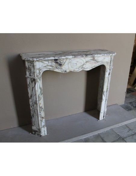 Baroque Pompadour fireplace mantel carved in magnificent Calacatta Gold marble: shades of gold, purple, emerald green, white.