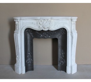 Baroque fireplace mantel in White Carrara marble with floral motifs, complete with decorative cast iron insert.