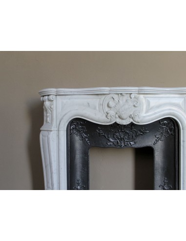 Baroque fireplace mantel in White Carrara marble with floral motifs, complete with decorative cast iron insert.