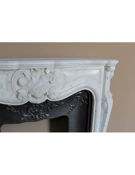Baroque fireplace mantel in White Carrara marble with floral motifs, complete with decorative cast iron insert.