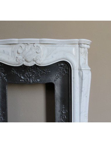 Baroque fireplace mantel in White Carrara marble with floral motifs, complete with decorative cast iron insert.