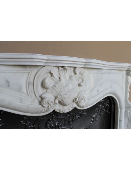 Baroque fireplace mantel in White Carrara marble with floral motifs, complete with decorative cast iron insert.