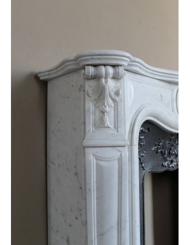 Baroque fireplace mantel in White Carrara marble with floral motifs, complete with decorative cast iron insert.