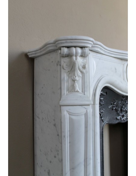Baroque fireplace mantel in White Carrara marble with floral motifs, complete with decorative cast iron insert.