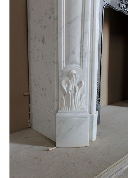 Baroque fireplace mantel in White Carrara marble with floral motifs, complete with decorative cast iron insert.