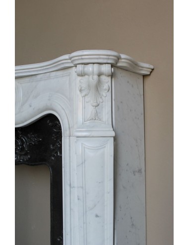 Baroque fireplace mantel in White Carrara marble with floral motifs, complete with decorative cast iron insert.