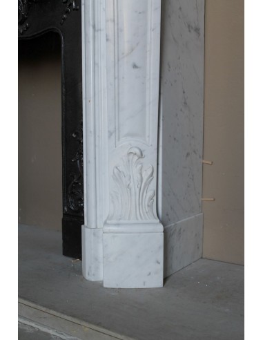 Baroque fireplace mantel in White Carrara marble with floral motifs, complete with decorative cast iron insert.