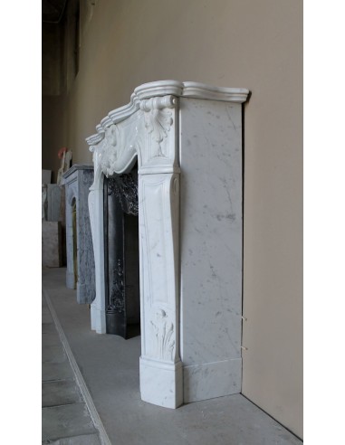 Baroque fireplace mantel in White Carrara marble with floral motifs, complete with decorative cast iron insert.