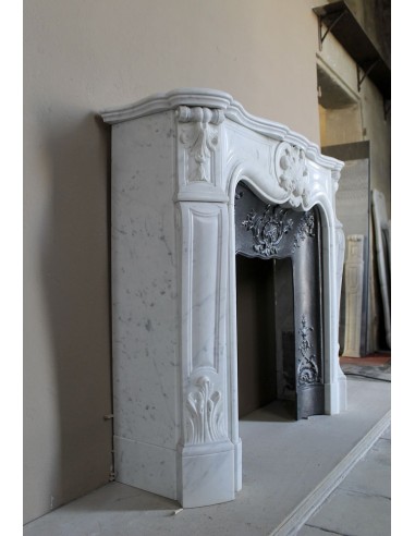 Baroque fireplace mantel in White Carrara marble with floral motifs, complete with decorative cast iron insert.