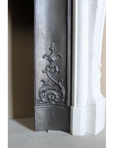 Baroque fireplace mantel in White Carrara marble with floral motifs, complete with decorative cast iron insert.