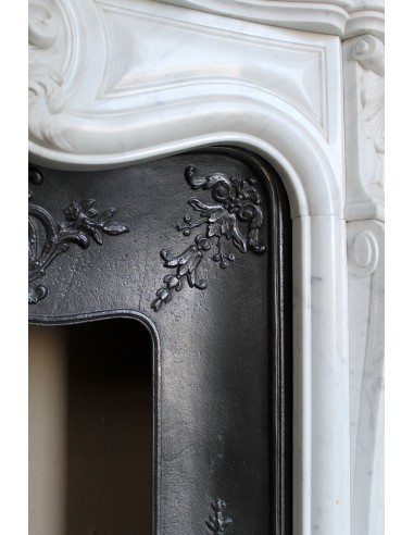 Baroque fireplace mantel in White Carrara marble with floral motifs, complete with decorative cast iron insert.