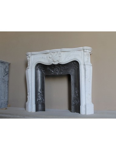 Baroque fireplace mantel in White Carrara marble with floral motifs, complete with decorative cast iron insert.