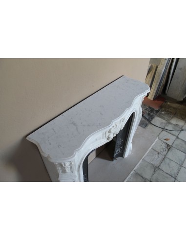 Baroque fireplace mantel in White Carrara marble with floral motifs, complete with decorative cast iron insert.