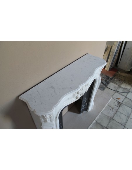 Baroque fireplace mantel in White Carrara marble with floral motifs, complete with decorative cast iron insert.