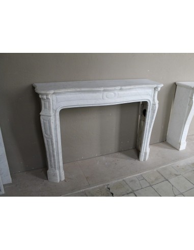 Genuine "Pompadour" fireplace mantel in pure white Carrara marble, featuring decorated bronze side openings.
