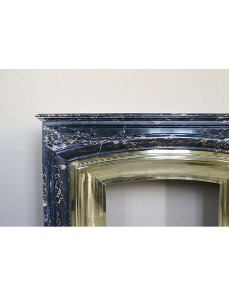 Antique Louis XIV "Boudin" fireplace mantel in exceptional black Portoro marble, complete with its original gilt brass insert.