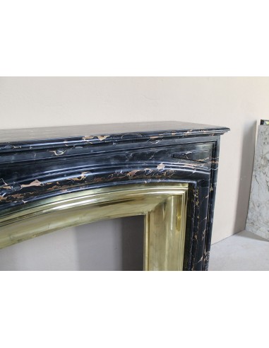 Antique Louis XIV "Boudin" fireplace mantel in exceptional black Portoro marble, complete with its original gilt brass insert.