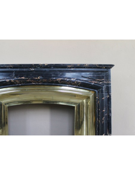 Antique Louis XIV "Boudin" fireplace mantel in exceptional black Portoro marble, complete with its original gilt brass insert.