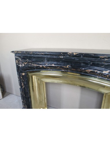 Antique Louis XIV "Boudin" fireplace mantel in exceptional black Portoro marble, complete with its original gilt brass insert.