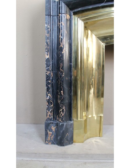 Antique Louis XIV "Boudin" fireplace mantel in exceptional black Portoro marble, complete with its original gilt brass insert.