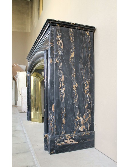 Antique Louis XIV "Boudin" fireplace mantel in exceptional black Portoro marble, complete with its original gilt brass insert.