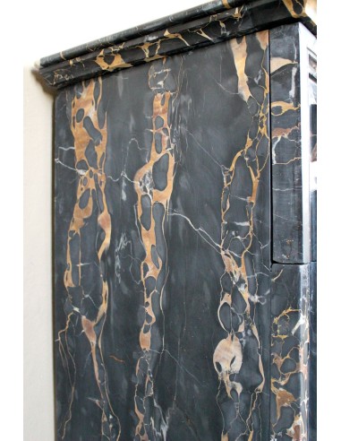 Antique Louis XIV "Boudin" fireplace mantel in exceptional black Portoro marble, complete with its original gilt brass insert.