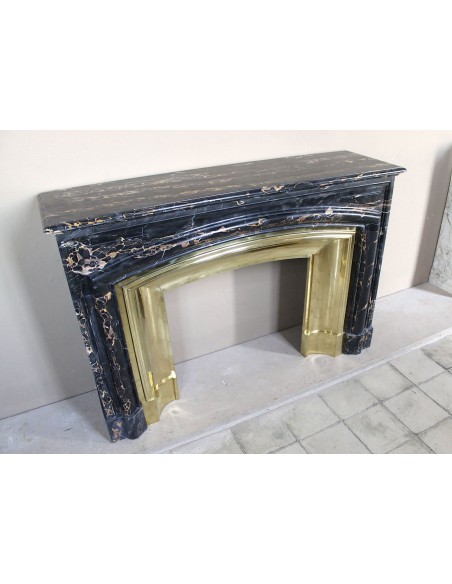 Antique Louis XIV "Boudin" fireplace mantel in exceptional black Portoro marble, complete with its original gilt brass insert.