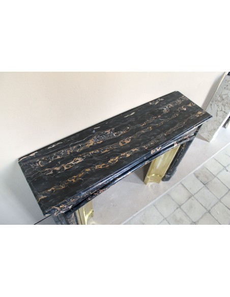 Antique Louis XIV "Boudin" fireplace mantel in exceptional black Portoro marble, complete with its original gilt brass insert.