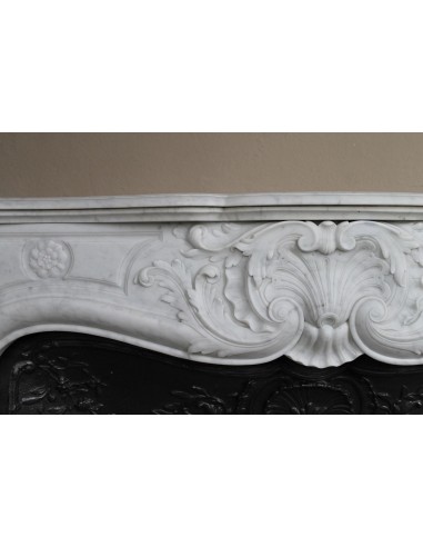 Antique Louis XV fireplace mantel in white marble with elegant floral decorations, with its original artistic cast-iron insert