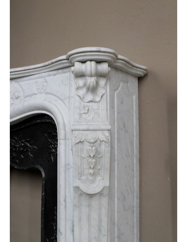 Antique Louis XV fireplace mantel in white marble with elegant floral decorations, with its original artistic cast-iron insert