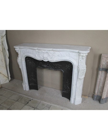 Antique Louis XV fireplace mantel in white marble with elegant floral decorations, with its original artistic cast-iron insert