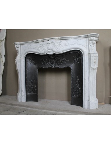 Antique Louis XV fireplace mantel in white marble with elegant floral decorations, with its original artistic cast-iron insert