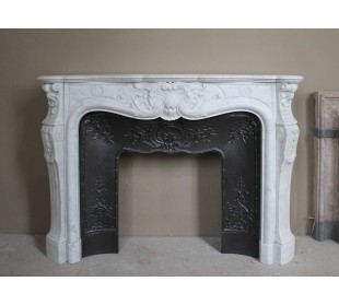 Antique Louis XV fireplace mantel in white marble with elegant floral decorations, with its original artistic cast-iron insert